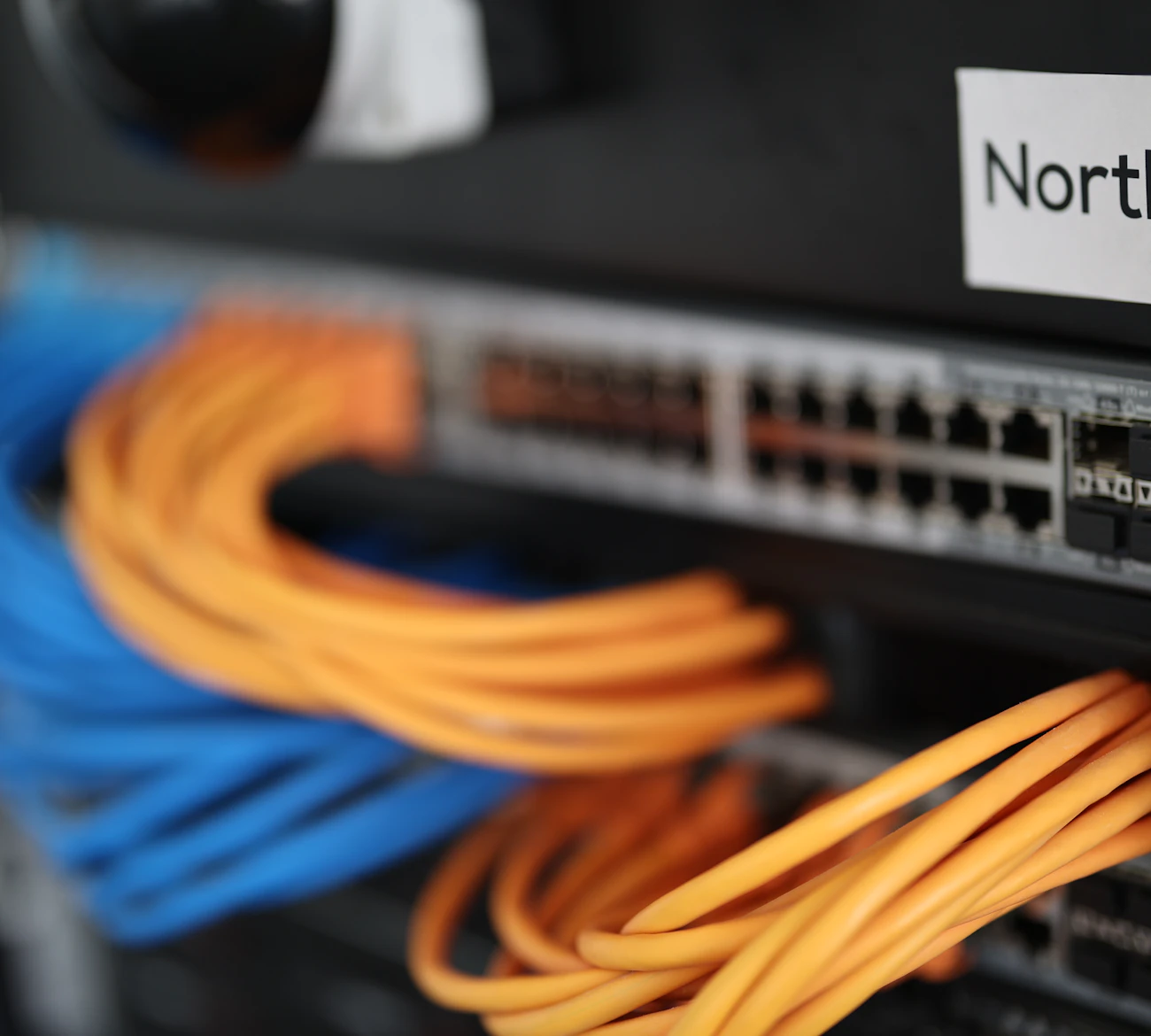Network switch with orange and blue cabling